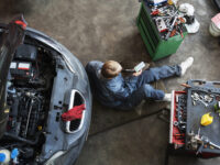 top-view-man-repairing-car